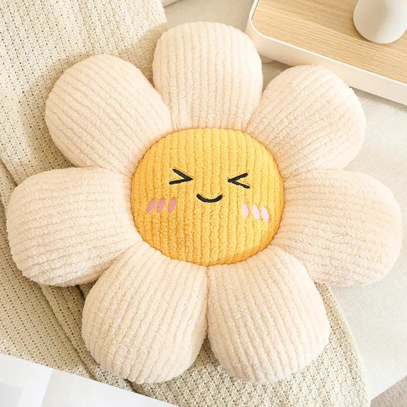 Flower-shaped kawaii pillow with a smiling face on a soft surface