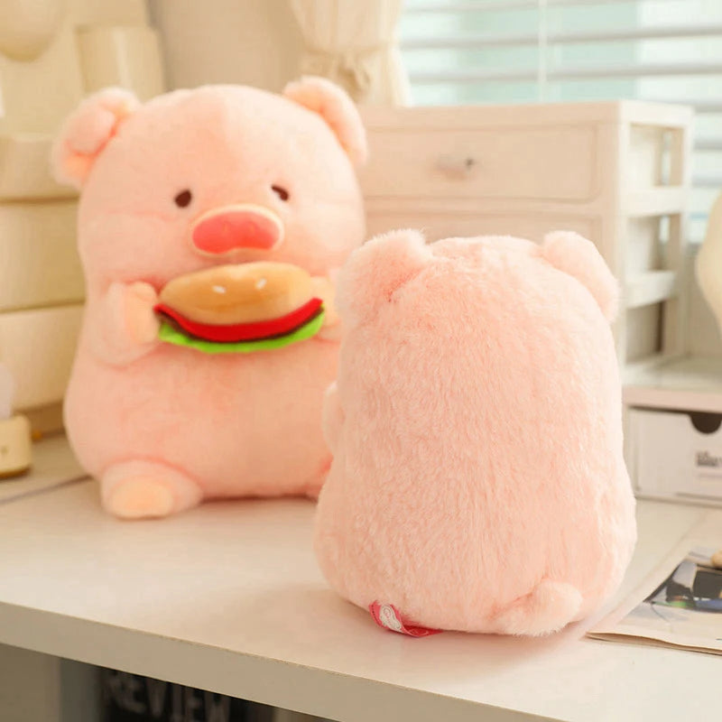 Pink kawaii plush toy resembling a bear with a hamburger on a desk