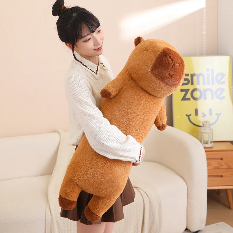 Woman holding a large brown kawaii teddy bear in a living room.