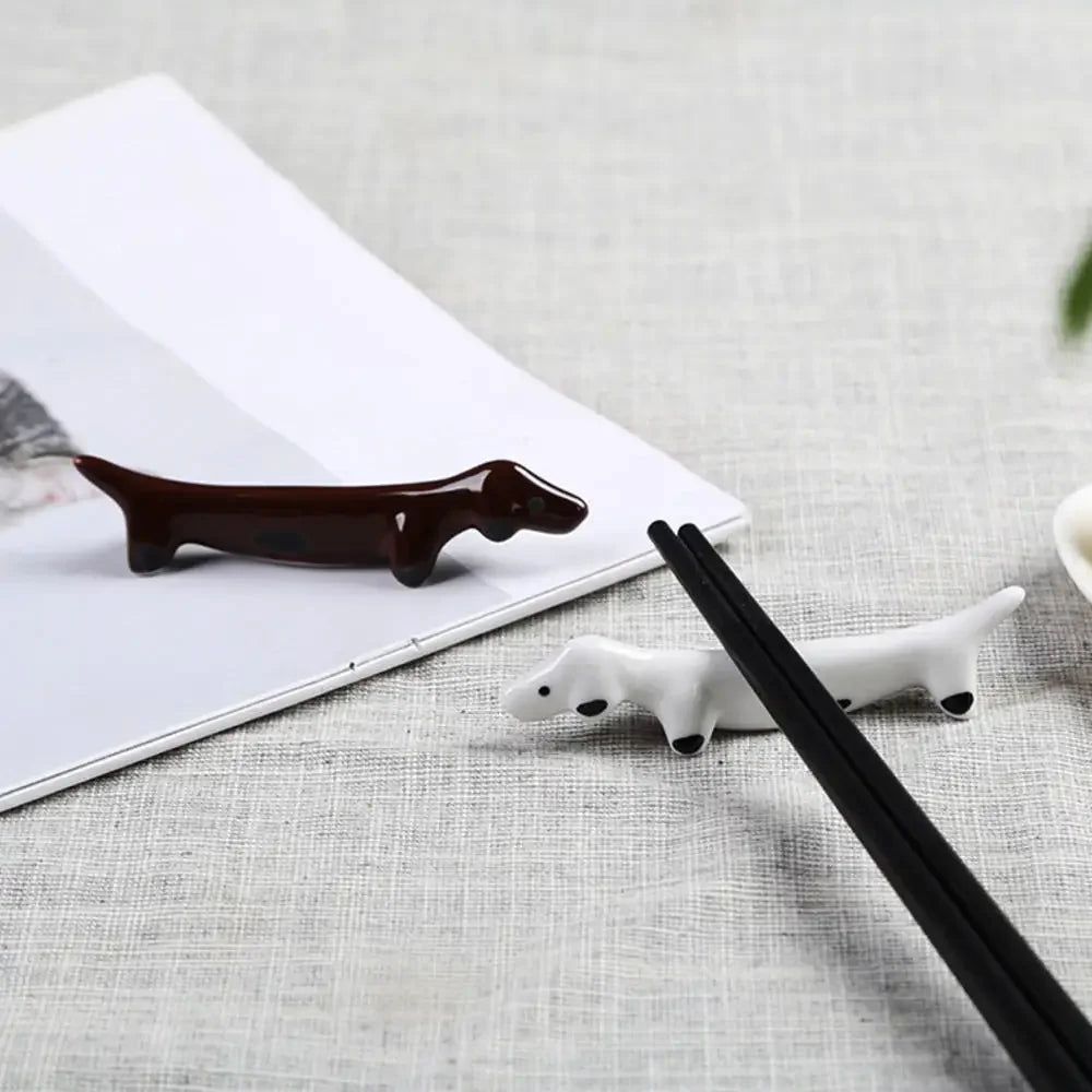 Two dog kawaii chopstick holders on a table
