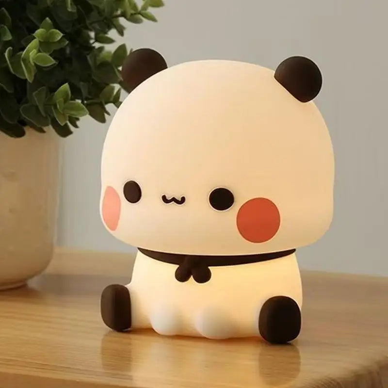 Cute panda-shaped kawaii night light on a wooden surface with a plant in the background