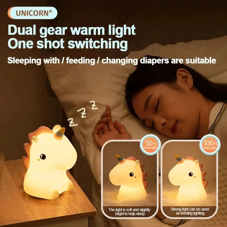Kawaii unicorn-shaped dual gear warm light on a nightstand next to a sleeping person.