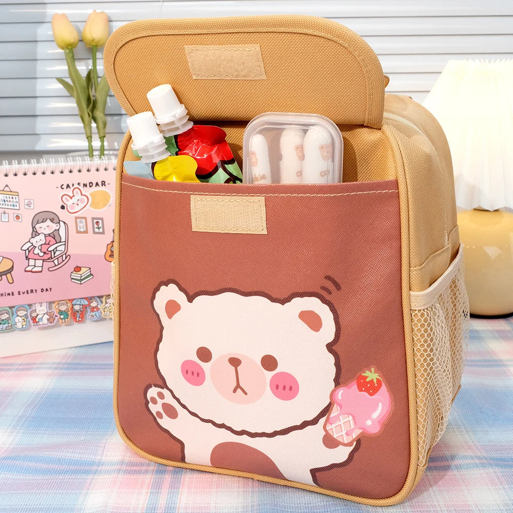 Kawaii lunch bag with a bear design on a table with flowers and a calendar in the background