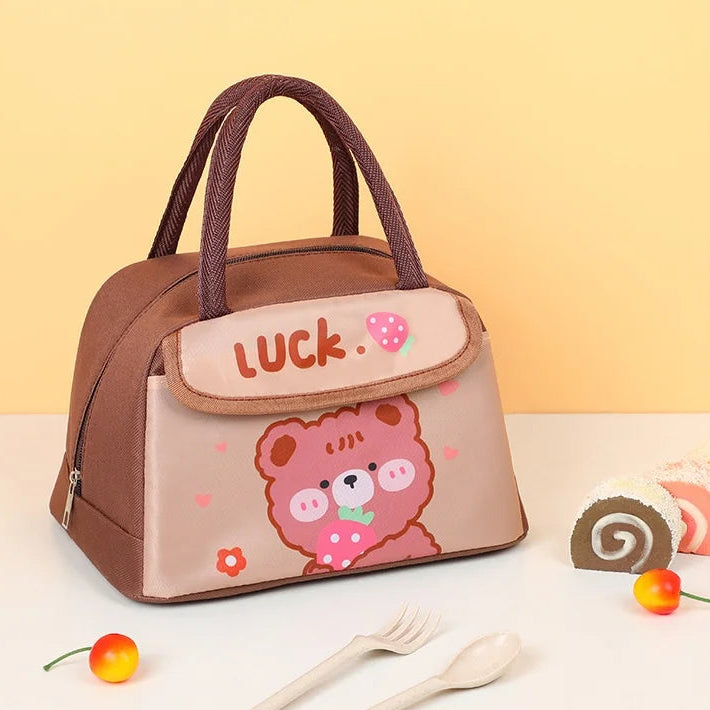 Kawaii lunch bag with cartoon design and 'luck' text on a light yellow background