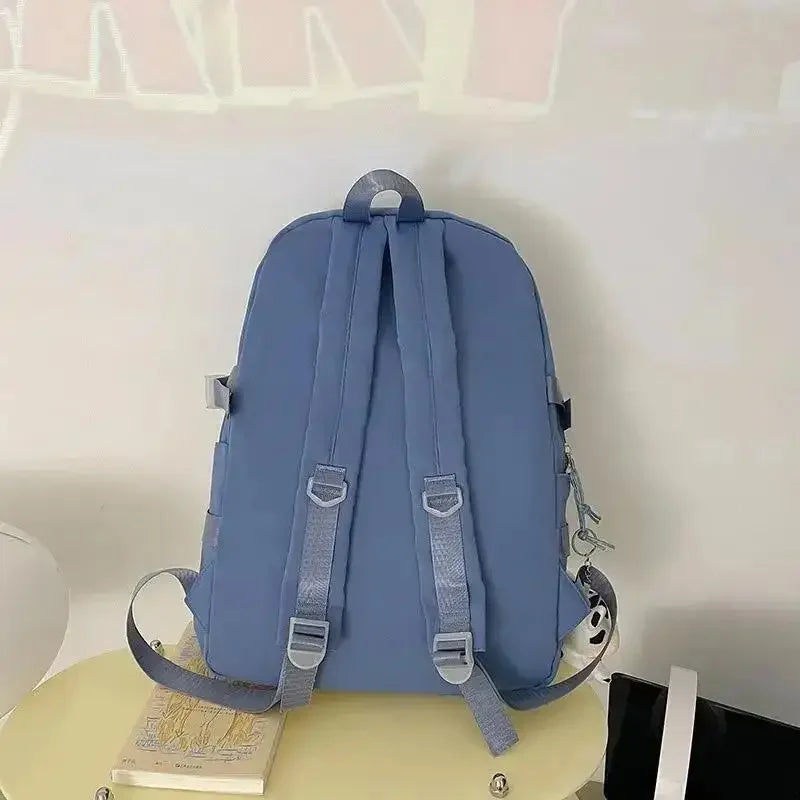 Kawaii blue backpack on a white surface with a blurred background