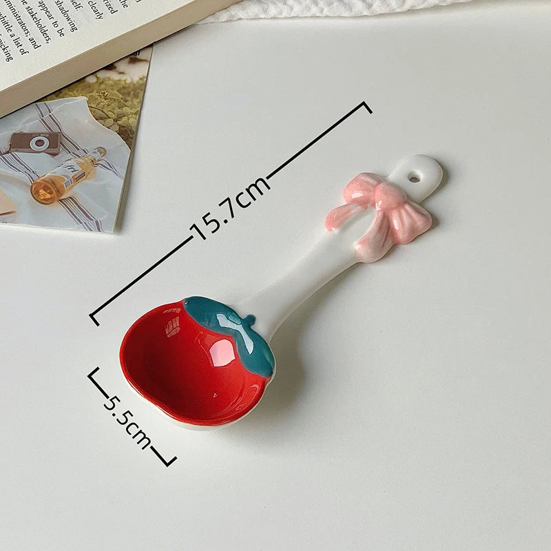 A white and red ceramic kawaii spoon on a table