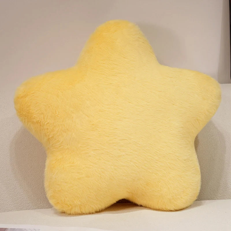 Yellow star-shaped pillow on a neutral background