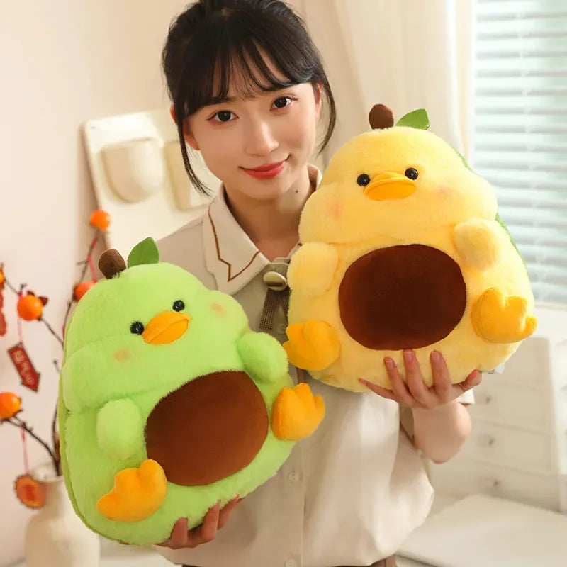 Person holding two kawaii plush toys shaped like avocados and ducks.