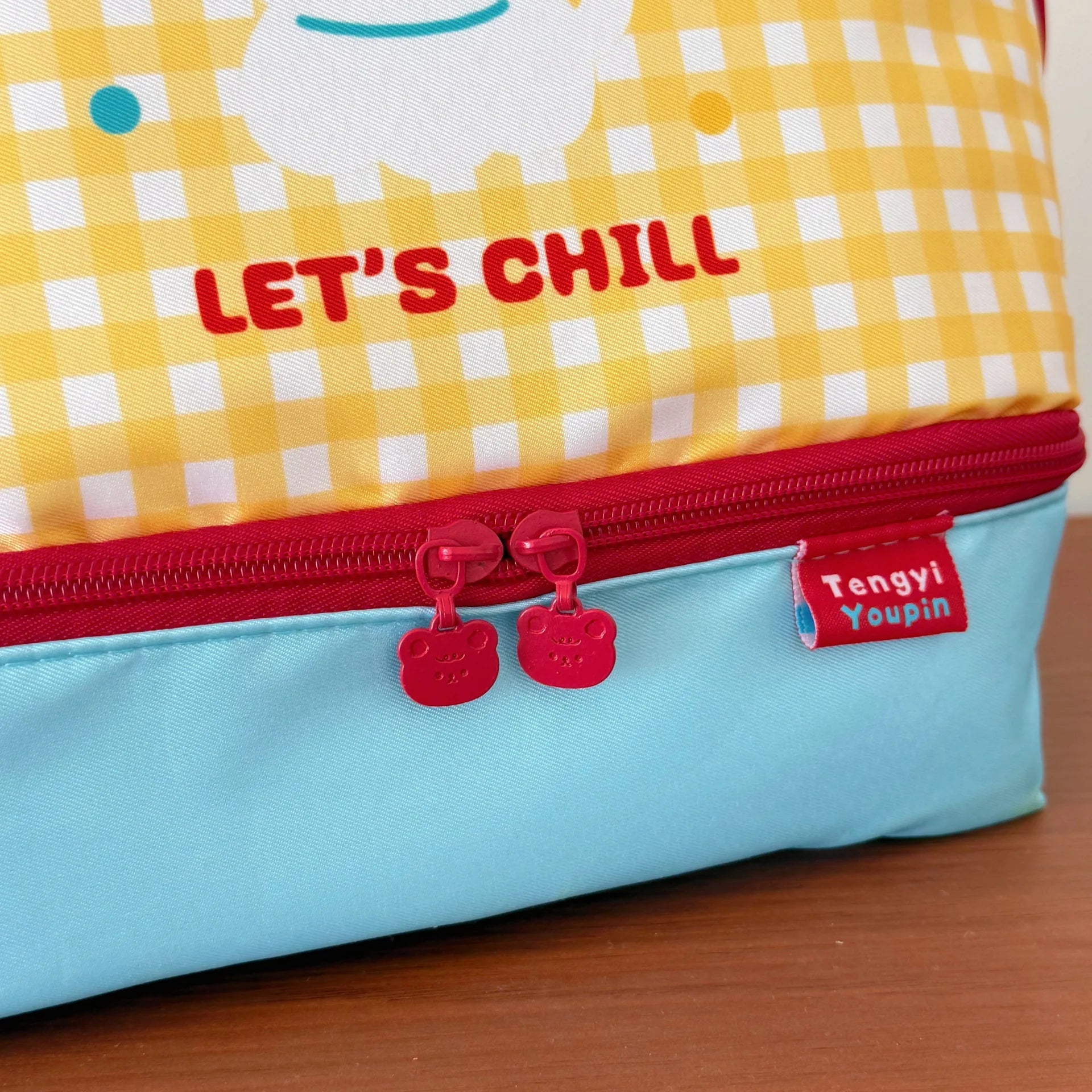 Children's kawaii bag with 'Let's Chill' text and checkered pattern on a wooden surface