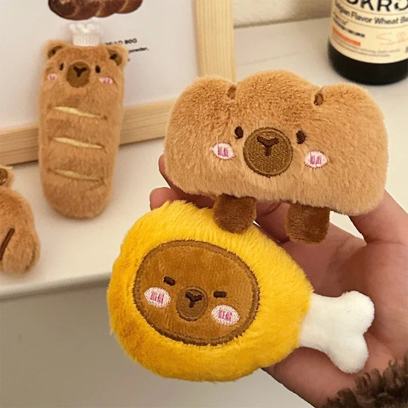 Plush kawaii bear toys in various shapes held by a hand with a blurred background.