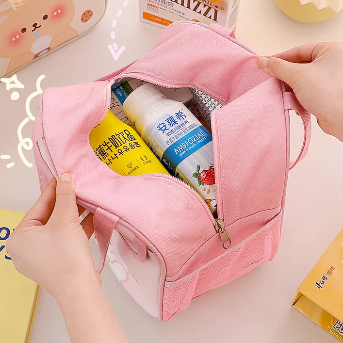 Pink kawaii toiletry bag with products inside, held by a hand on a light background.