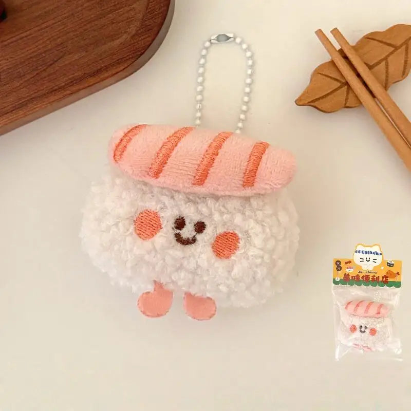 Plush kawaii keychain shaped like a snowman with a bread loaf on its head, placed on a light surface with chopsticks and a wooden item in the background.