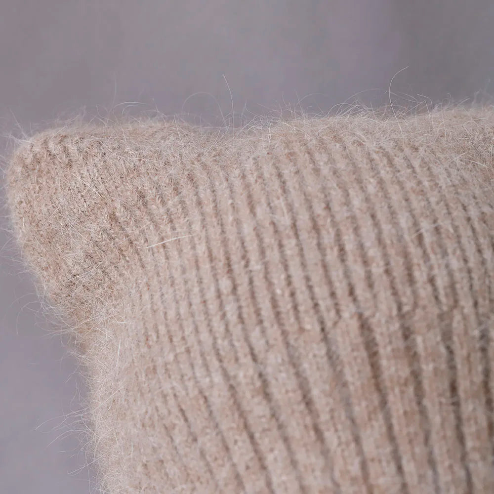 Close-up of a textured beige Kawaii hat against a neutral background