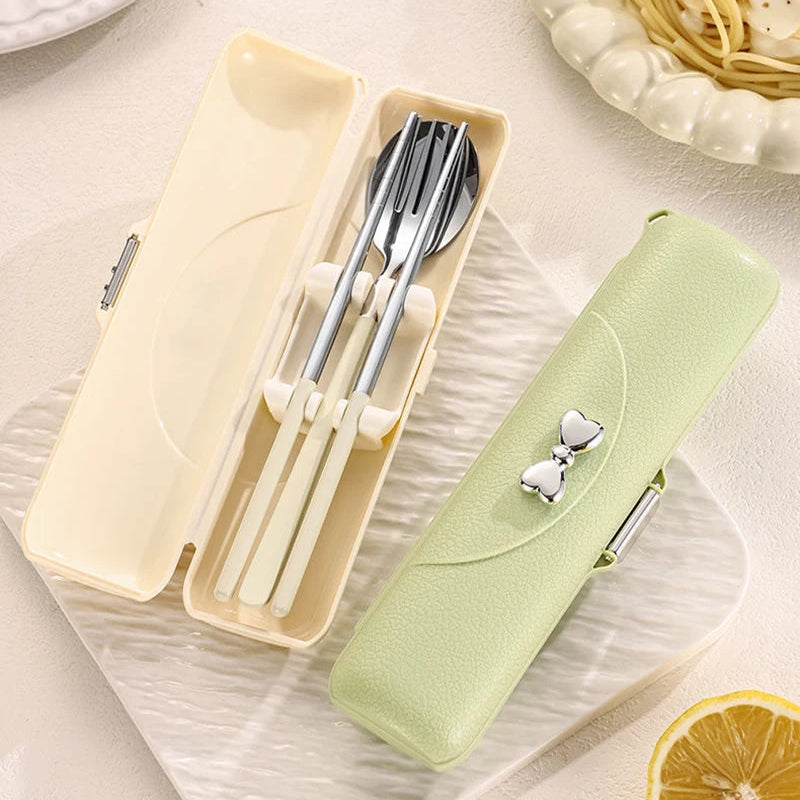 Set of kawaii utensils in a beige case with a green pouch on a light background