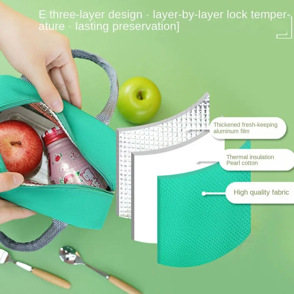 Green cooler kawaii bag with apples and a bottle on a green background, showing features like thick fresh-keeping aluminum film and high-quality fabric.