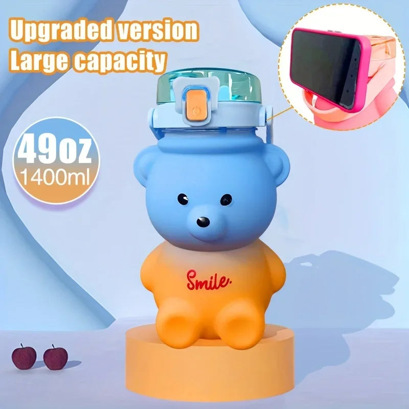 Blue bear-shaped kawaii water bottle with a phone holder on a light blue background