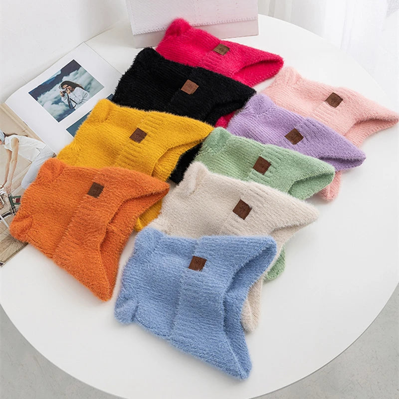 Colorful Kawaii hats arranged on a white surface with a magazine in the background.