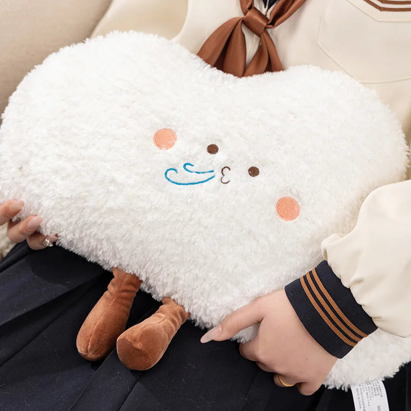 Kawaii plush toy resembling a sheep held by a person on a beige couch.
