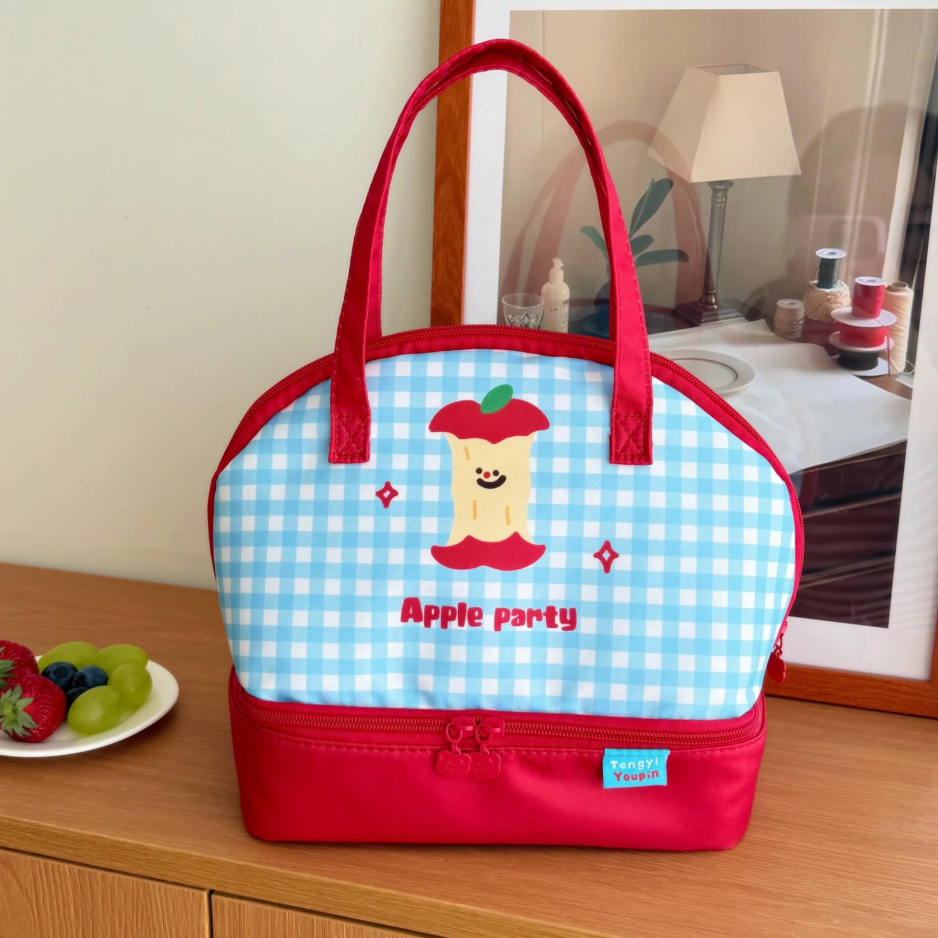 Insulated kawaii lunch bag with cartoon design on a wooden surface