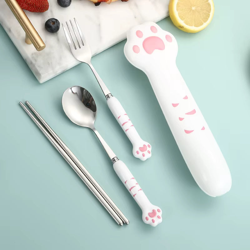 Set of kawaii utensils with paw design handles on a light blue background