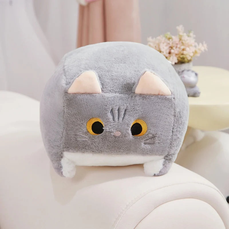 Kawaii plush cat toy on a white surface with a blurred background