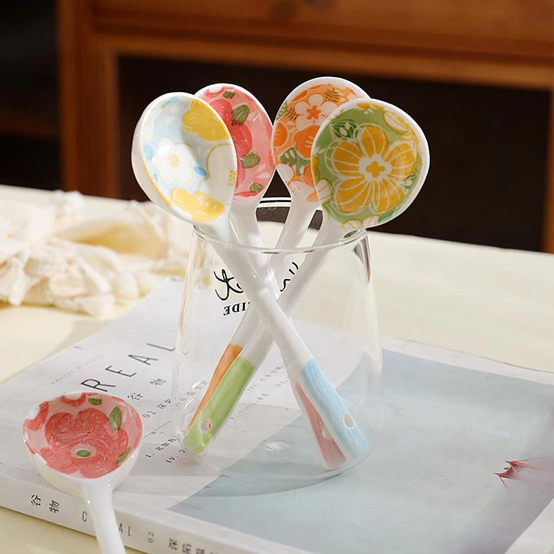 Four flower designed kawaii spoons inside a glass
