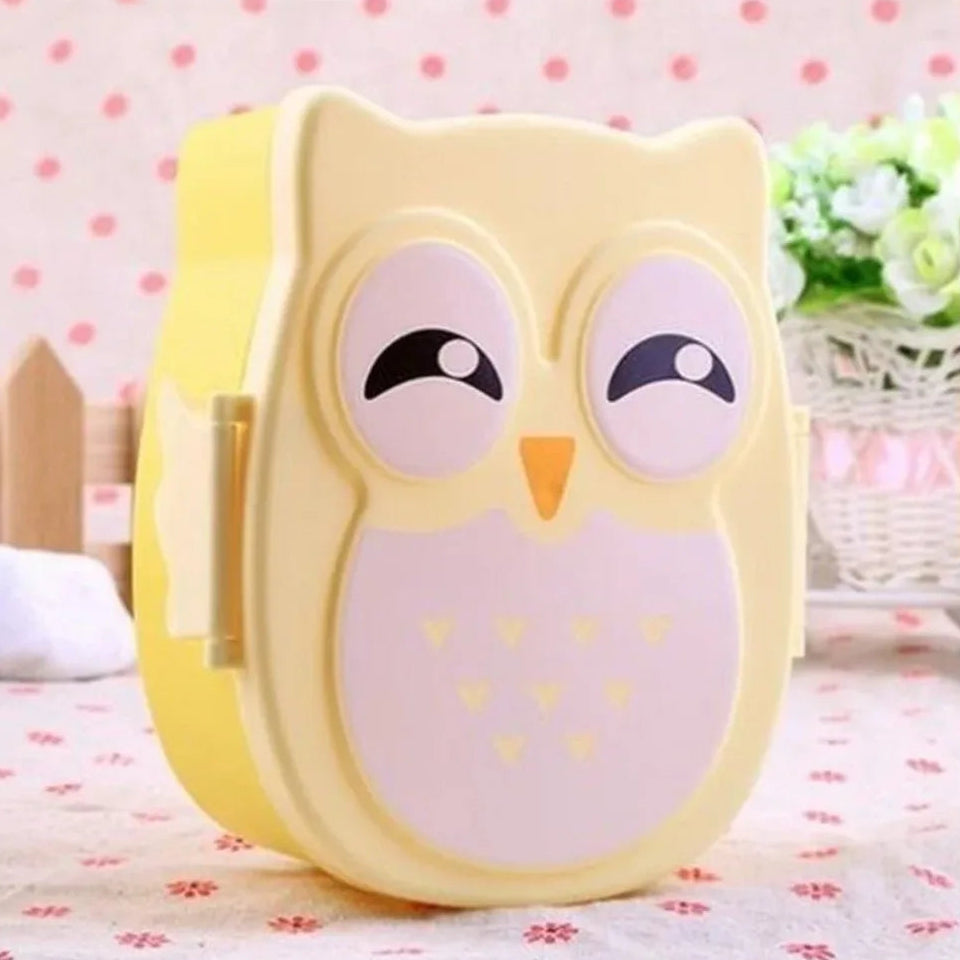 Yellow owl-shaped kawaii food container on a polka dot background