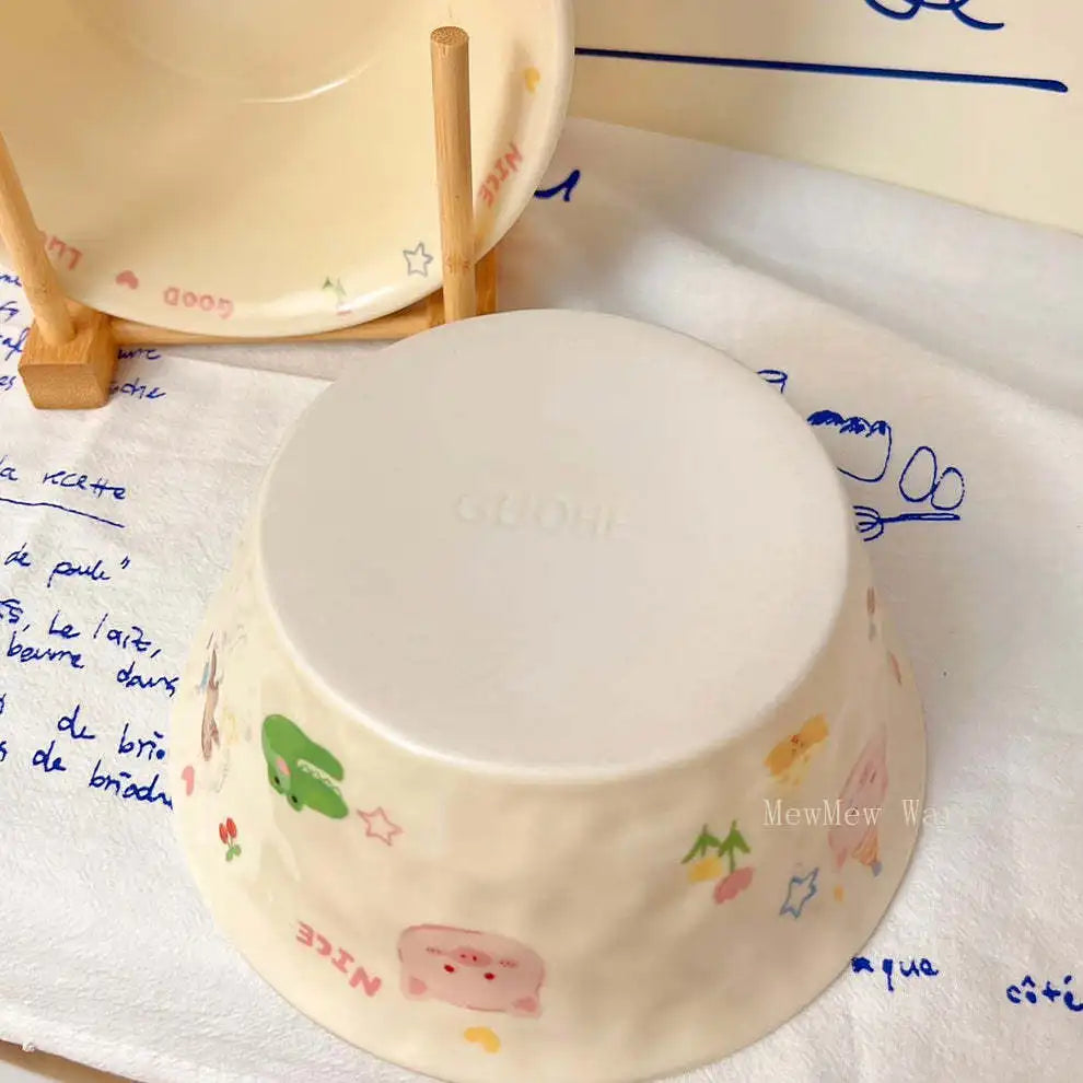 White ceramic kawaii ramen bowl with colorful patterns on a white surface with writing