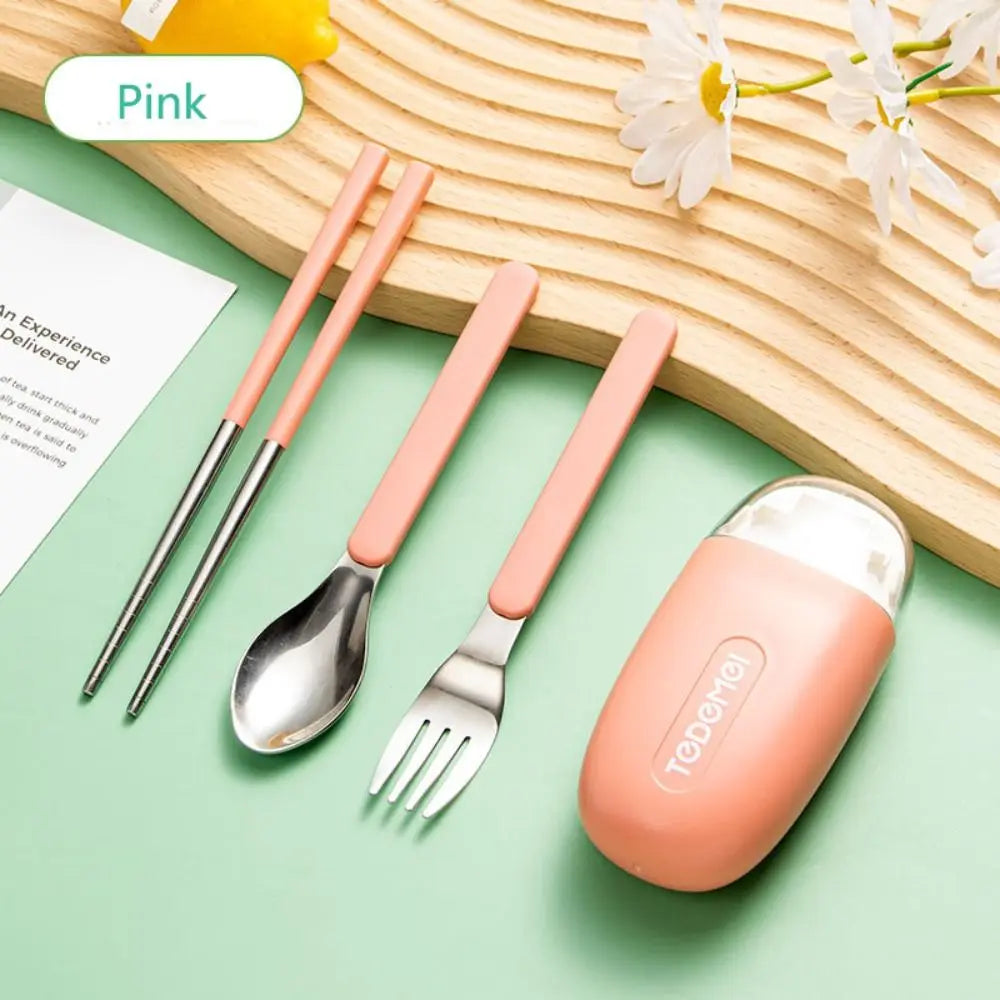 Pink kawaii utensils set with case on a green surface