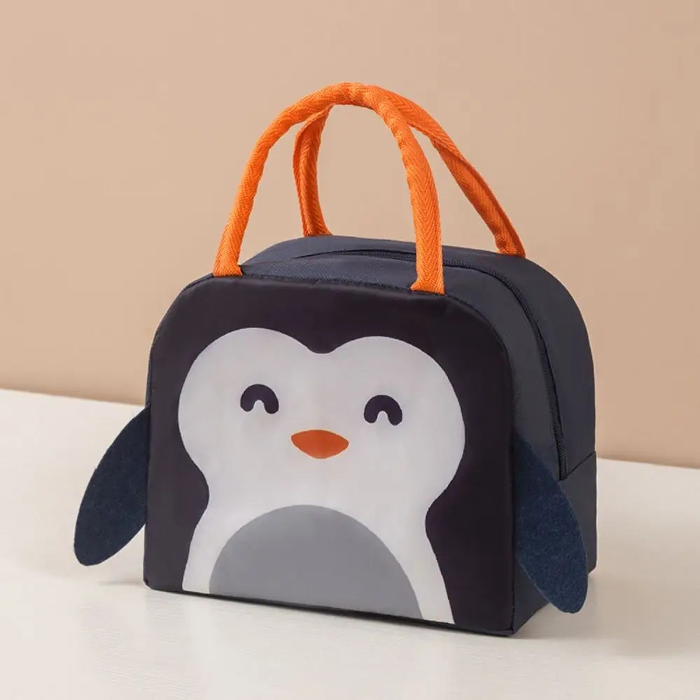 Penguin-themed kawaii lunch bag with orange handles on a beige background