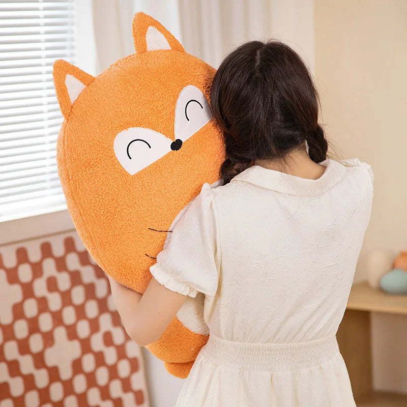 Person holding a large orange fox-shaped kawaii pillow