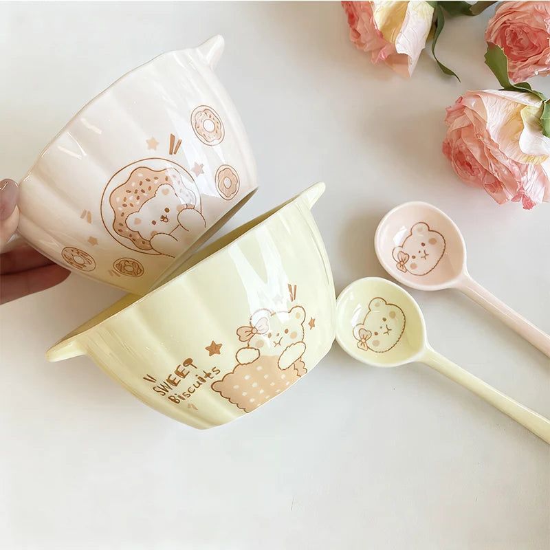 Cute ceramic kawaii bowl set with bear illustrations on a light surface with flowers.