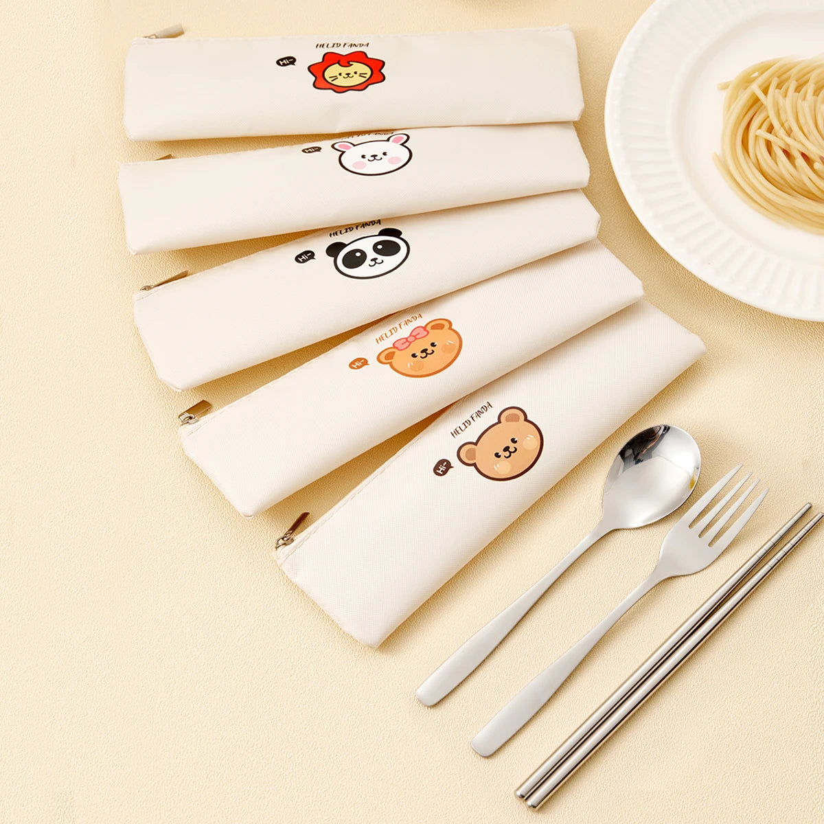 Set of white kawaii utensils with cartoon animal faces, silver cutlery on a beige background