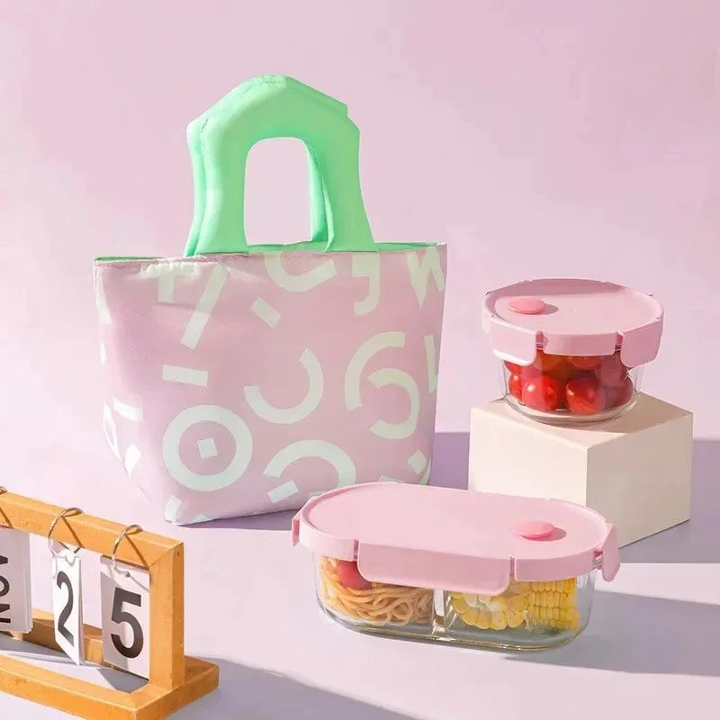 Pink kawaii tote bag with green handle next to two pink containers with food on a light purple background