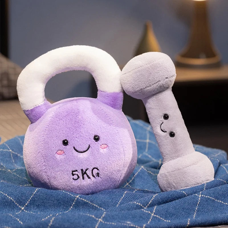 Kawaii plush toy dumbbell and kettlebell with smiling faces on a blue textured surface