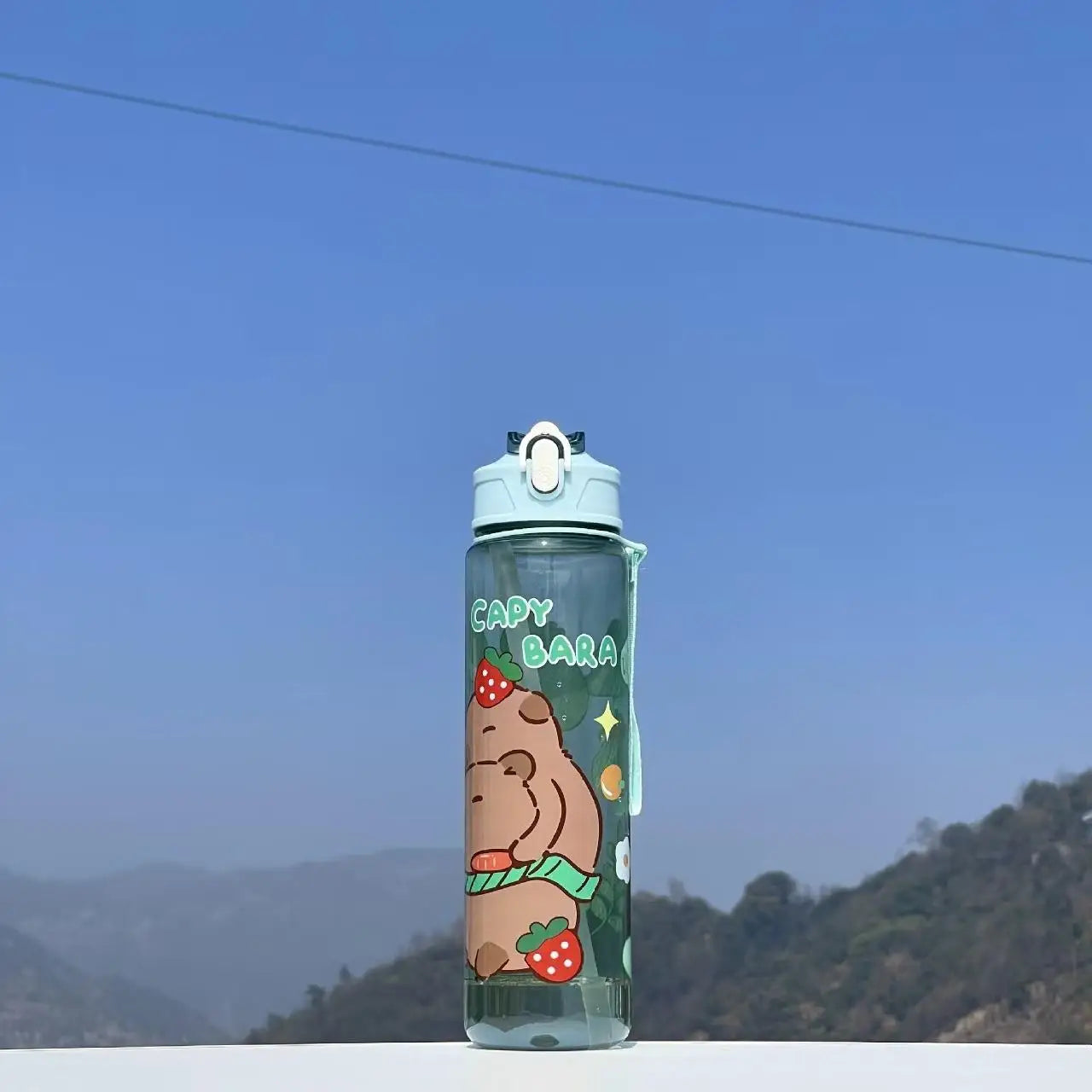Capybara kawaii water bottle with a scenic background