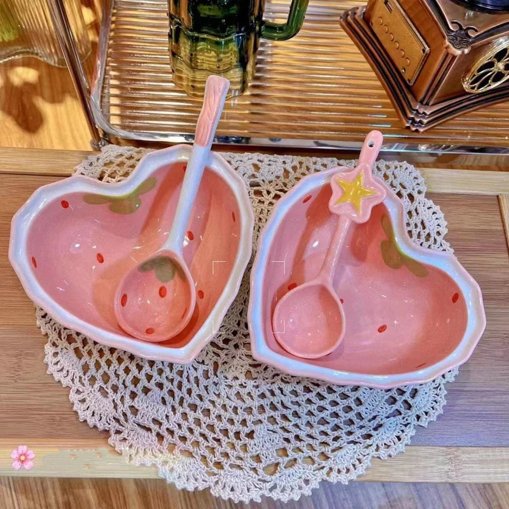 Two strawberry heart shaped kawaii bowls on a table