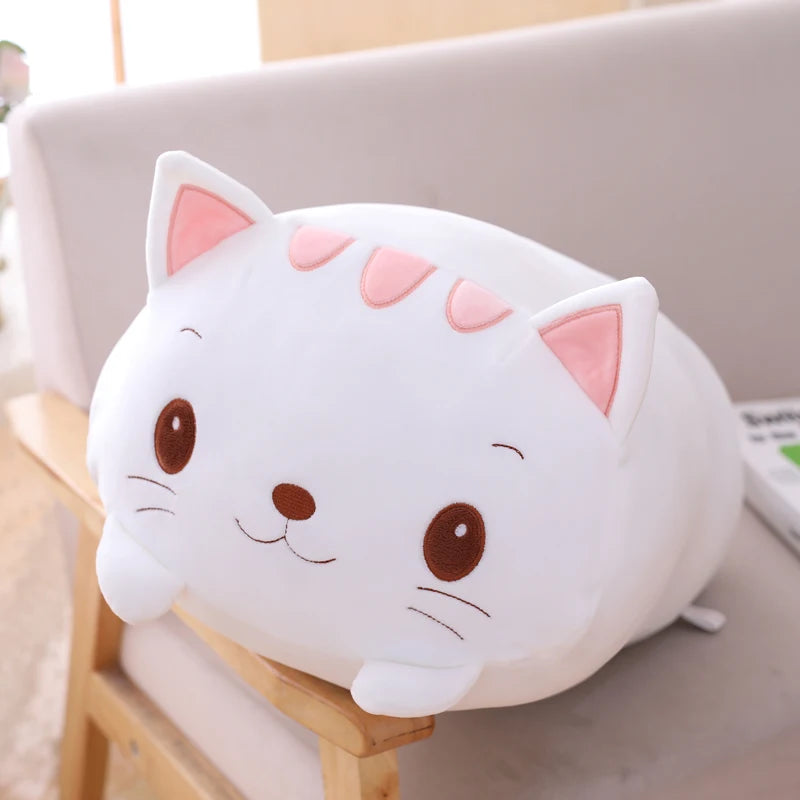 Cute kawaii cat-shaped plush toy on a surface with a blurred background