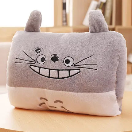 Plush kawaii pillow with cartoon face design on a wooden surface