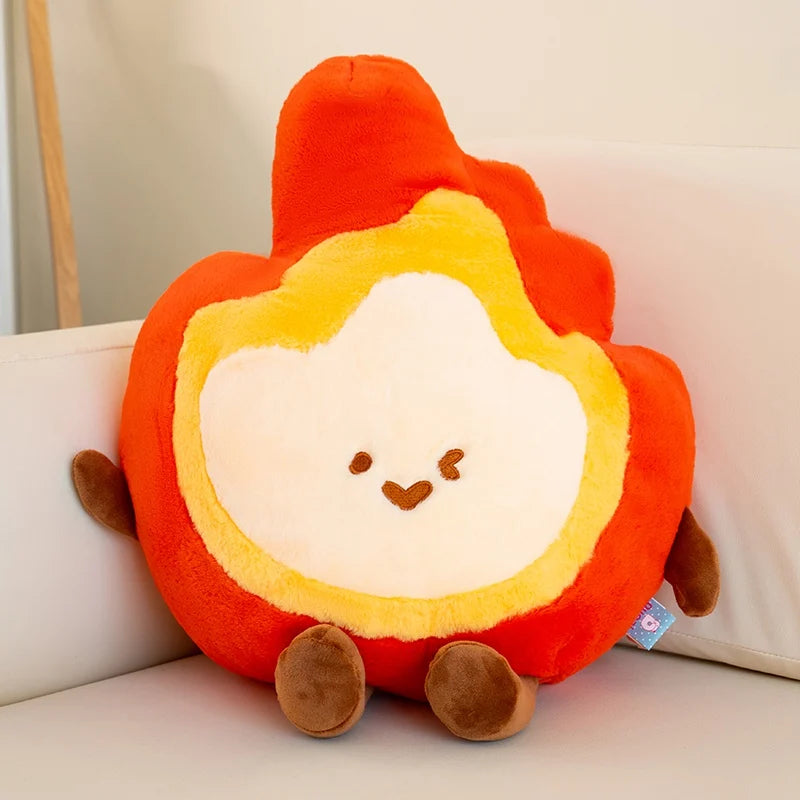 Kawaii plush toy shaped like a fire with a face on a light-colored couch.
