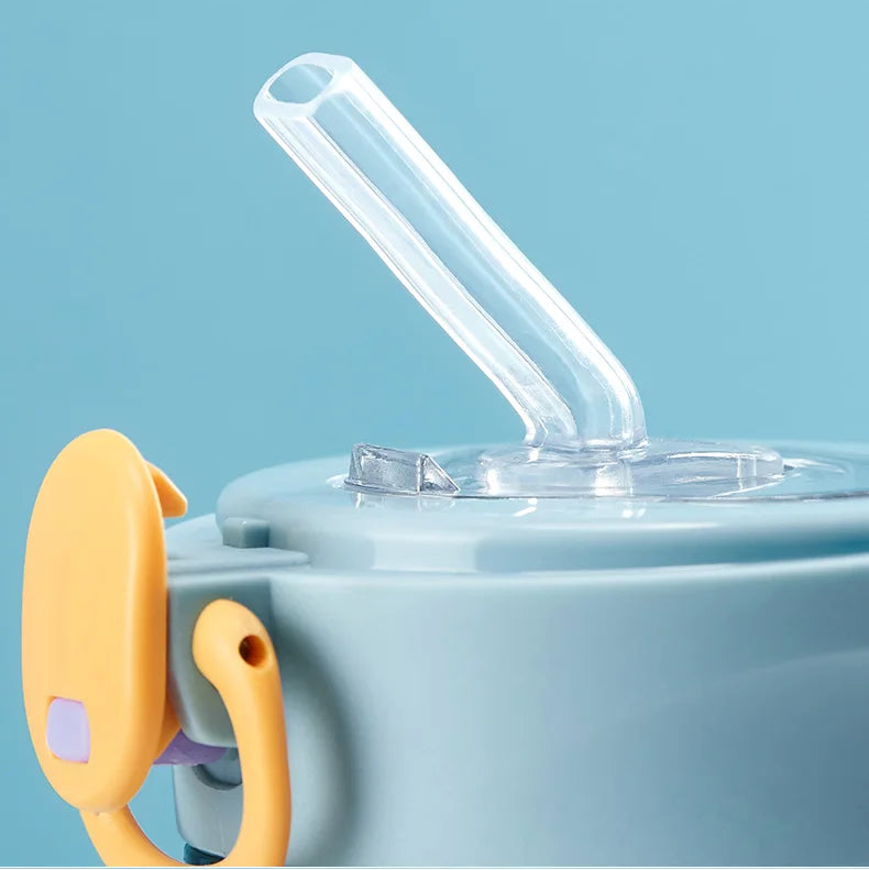Close up of a clear silicone straw of a kawaii water bottle with a blue background and text 'Silicone for potable water'.