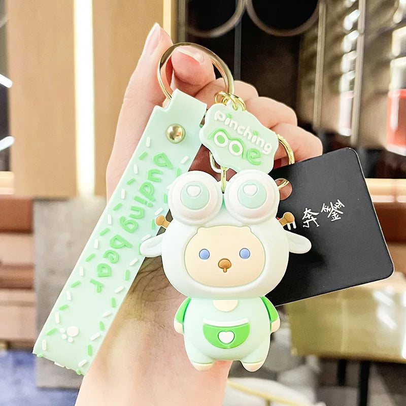 Keychain with a kawaii cute character held by a hand, with a blurred background