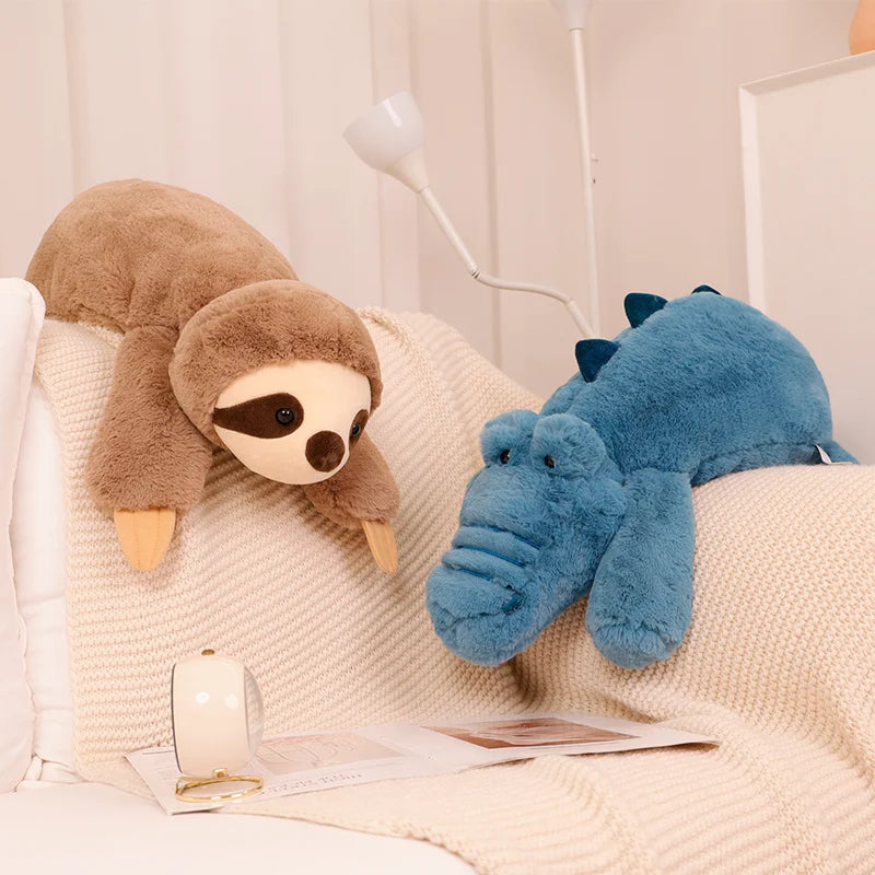 Kawaii plush sloth and hippo toys on a textured surface with a lamp in the background