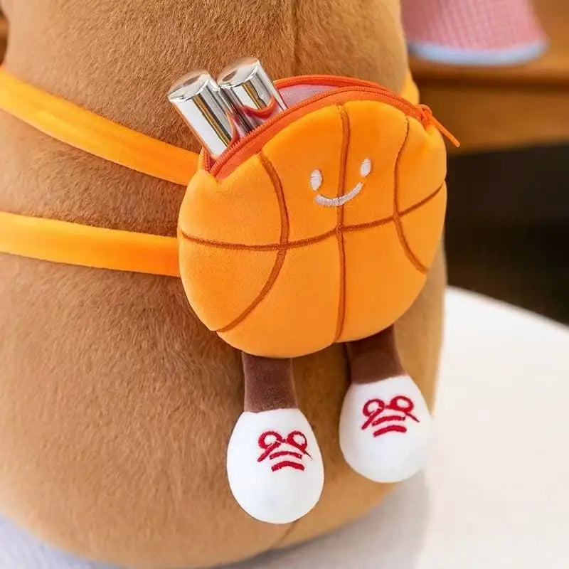 Kawaii plush basketball toy with a face and legs attached to a small pouch, worn around the waist.