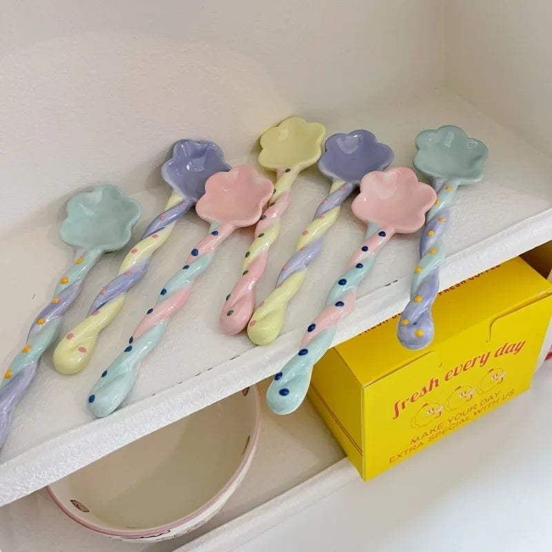 A group of ceramic kawaii spoons on a sheld