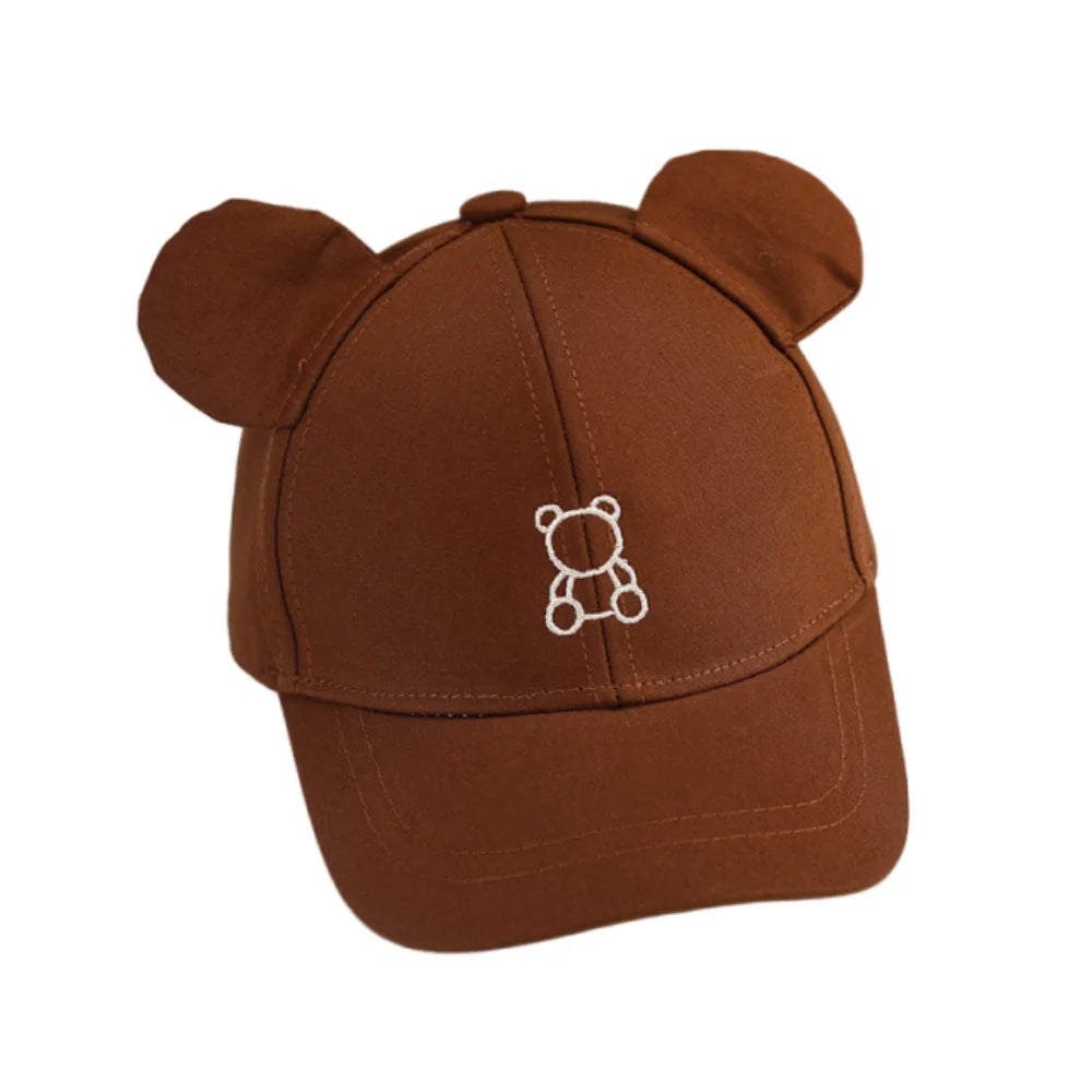 Brown Kawaii cap with bear ears and a white bear emblem on a white background