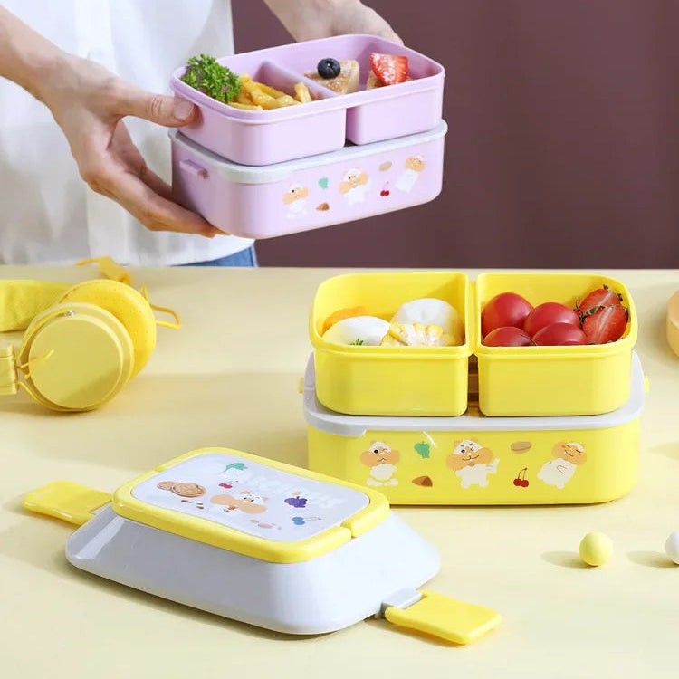 Colorful kawaii bento boxes with compartments filled with food on a table.