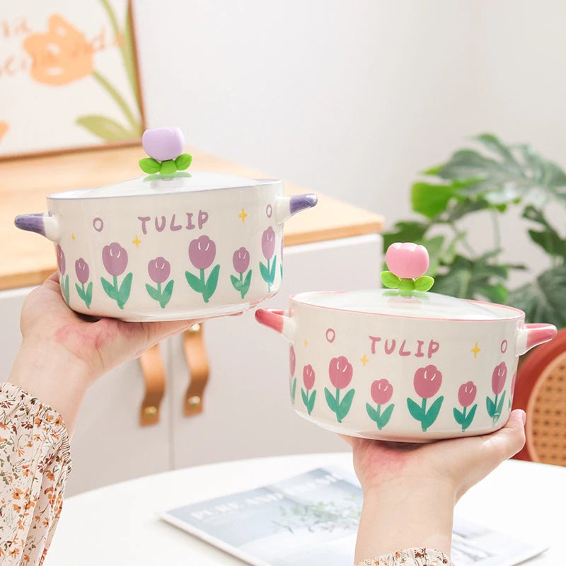 Two ceramic kawaii ramen bowls with tulip designs and 'Tulip' text, held by a person.