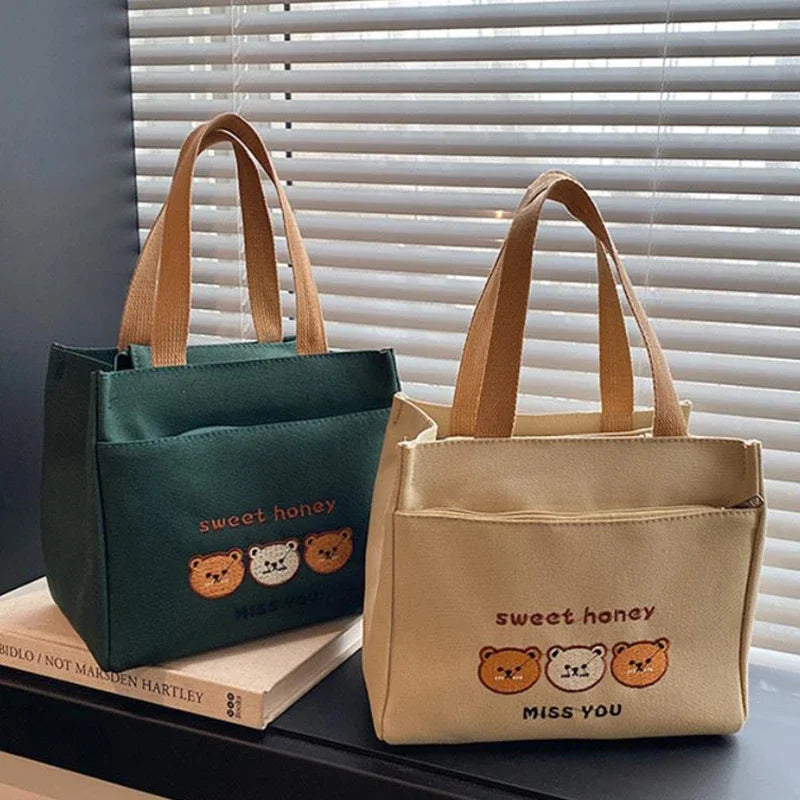 Two kawaii tote bags, one green and one beige, with 'sweet honey' text and bear illustrations on a surface.