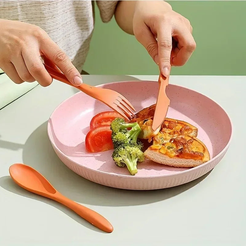 A person eating food with a set of orange kawaii utensils